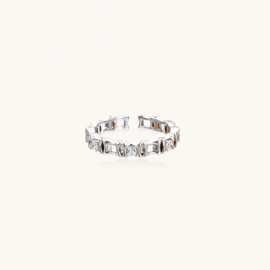 White gold plated ring with architectural lattice design and zirconia accents on cream background