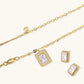 Gold-plated jewelry set with rectangular cubic zirconia stones in pave halo settings on cream background