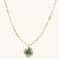 Gold-plated flower jewelry set with blue zirconia center petals and clear crystal outer petals on neutral background.