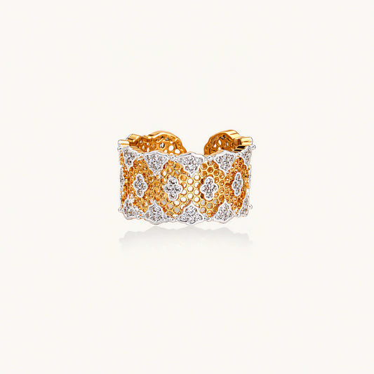 Two-tone gold and silver lattice ring with clover pattern and crystal accents on white background