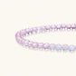 Double-wrap lavender beaded bracelet with rose quartz, pearls, gold vermeil charm and pink tassel on white background.