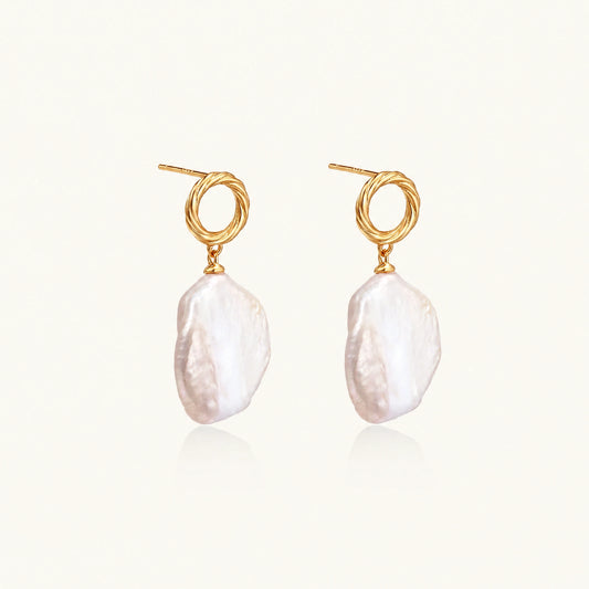 18K gold vermeil twisted circle studs with organic white baroque pearl drops on cream background