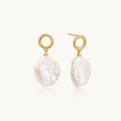 18K gold vermeil twisted circle studs with organic white baroque pearl drops on cream background