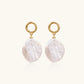 18K gold vermeil twisted circle studs with organic white baroque pearl drops on cream background