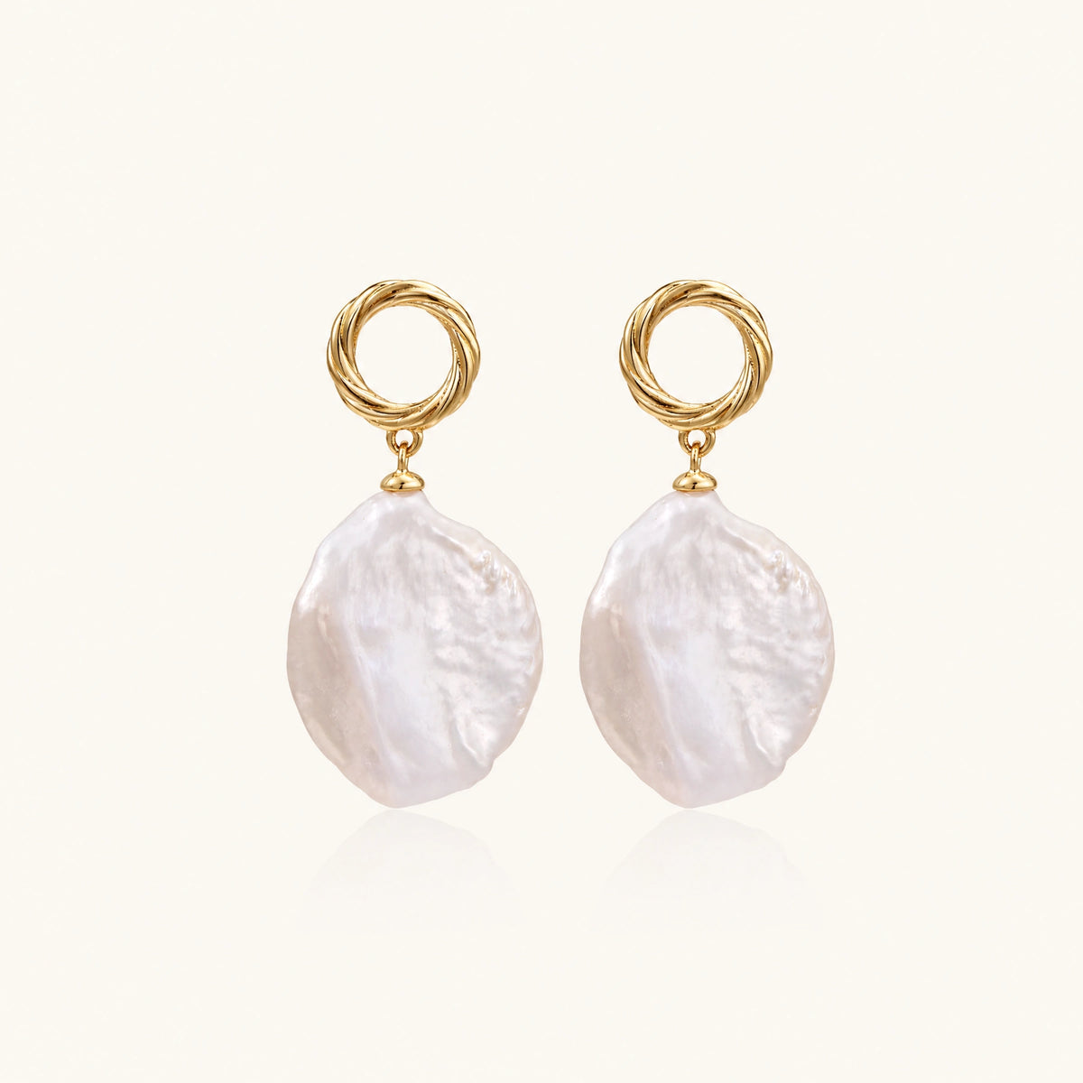 18K gold vermeil twisted circle studs with organic white baroque pearl drops on cream background