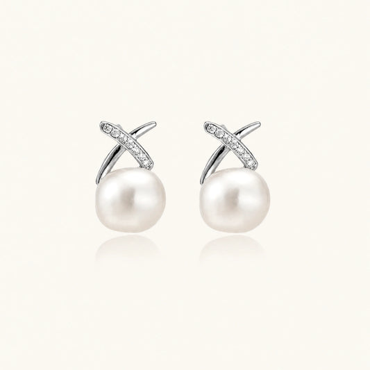 Rhodium-plated silver stud earrings with sparkling X design above lustrous round freshwater pearls on white background.