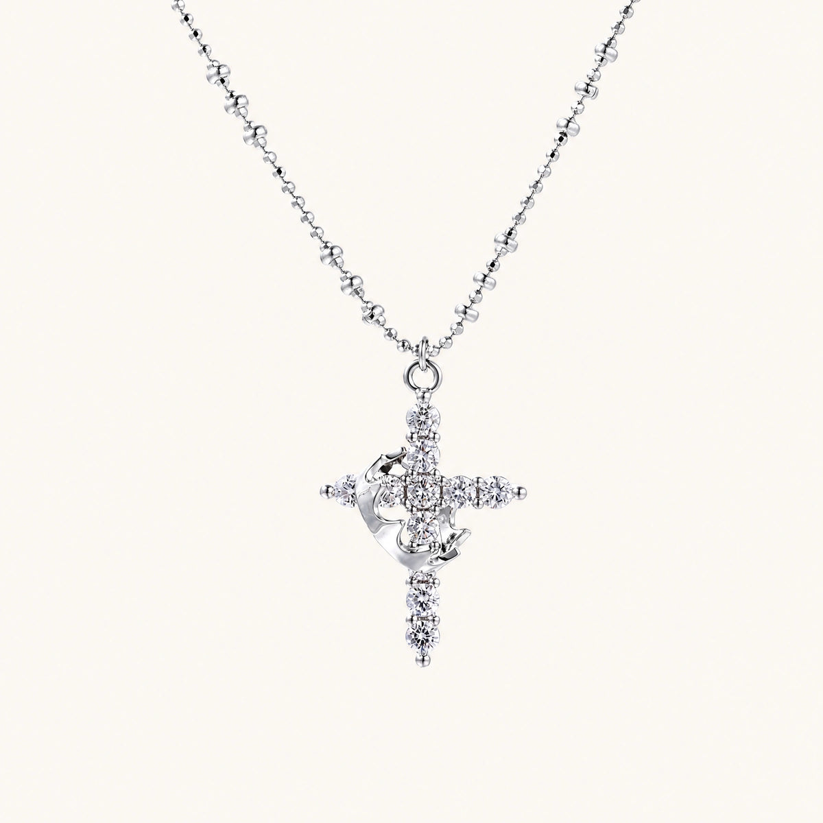 White gold-plated cross pendant adorned with sparkling zirconia stones and crescent moon accent on ball chain