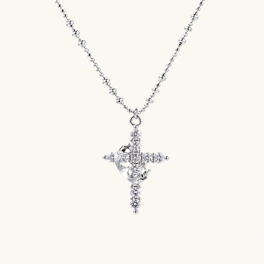 White gold-plated cross pendant adorned with sparkling zirconia stones and crescent moon accent on ball chain