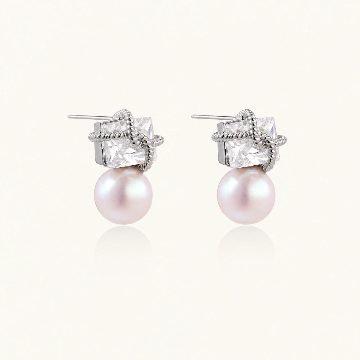 White gold stud earrings with square crystal stones in twisted frames and pink freshwater pearl drops below