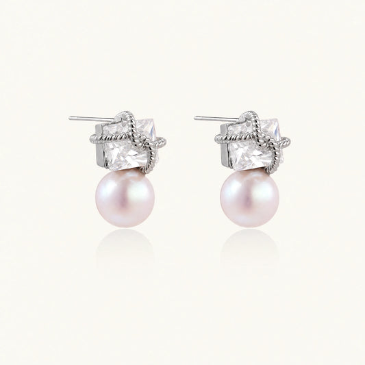 White gold stud earrings with square crystal stones in twisted frames and pink freshwater pearl drops below
