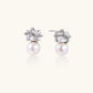 White gold stud earrings with square crystal stones in twisted frames and pink freshwater pearl drops below