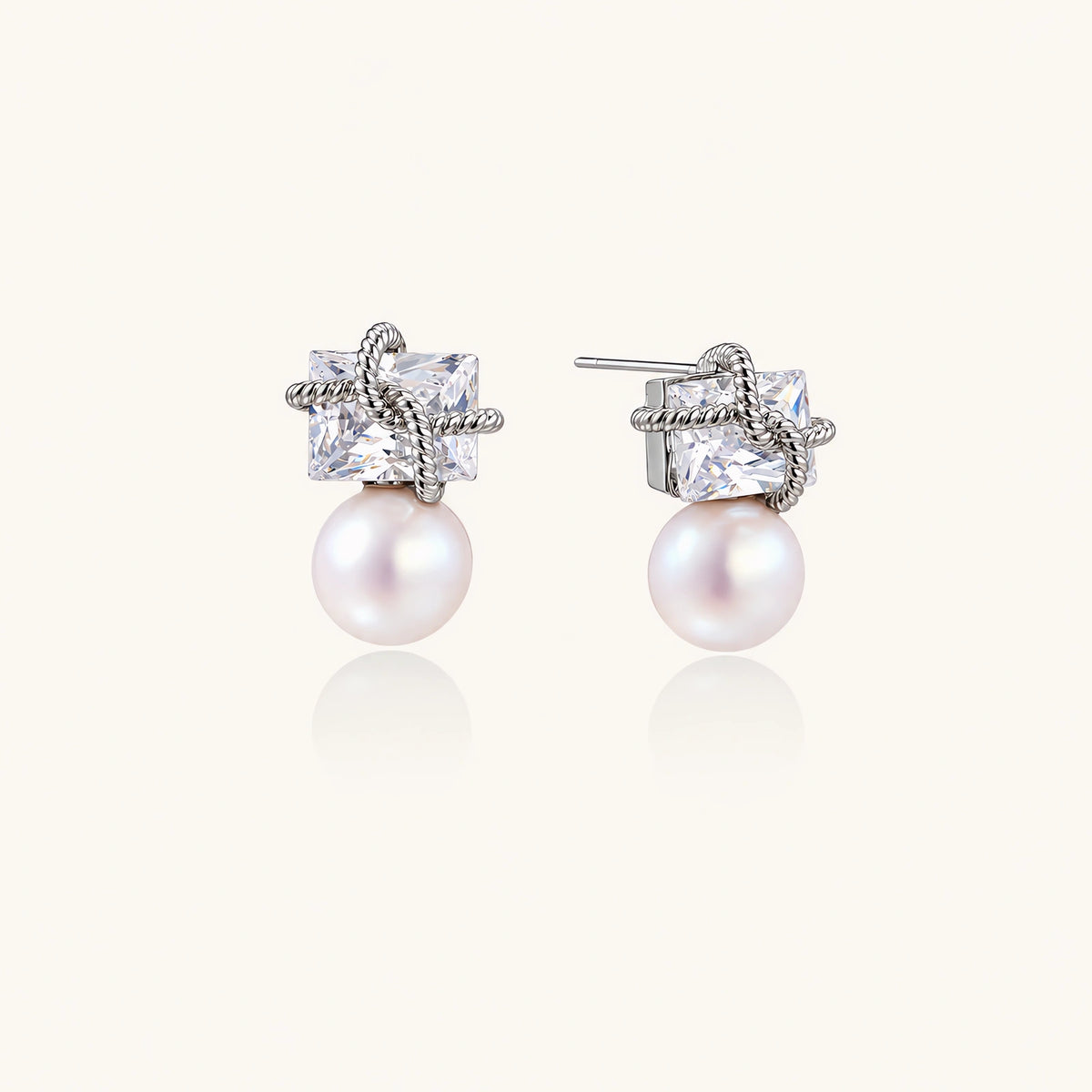White gold stud earrings with square crystal stones in twisted frames and pink freshwater pearl drops below