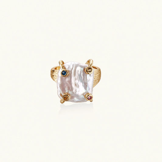 Gold ring with large iridescent baroque pearl and four colored gemstones on textured band