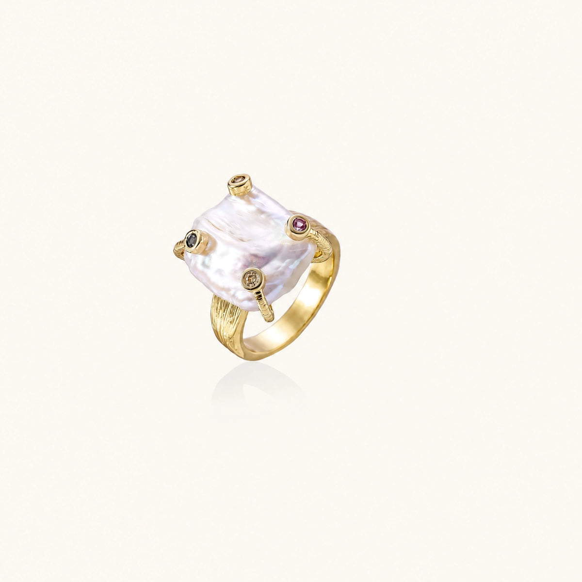 Gold ring with large iridescent baroque pearl and four colored gemstones on textured band