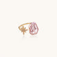 Adjustable gold ring with pink baroque freshwater pearl and crystal-studded star charm on white background
