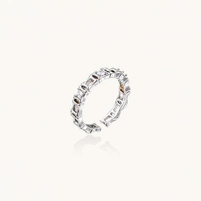White gold plated ring with architectural lattice design and zirconia accents on cream background